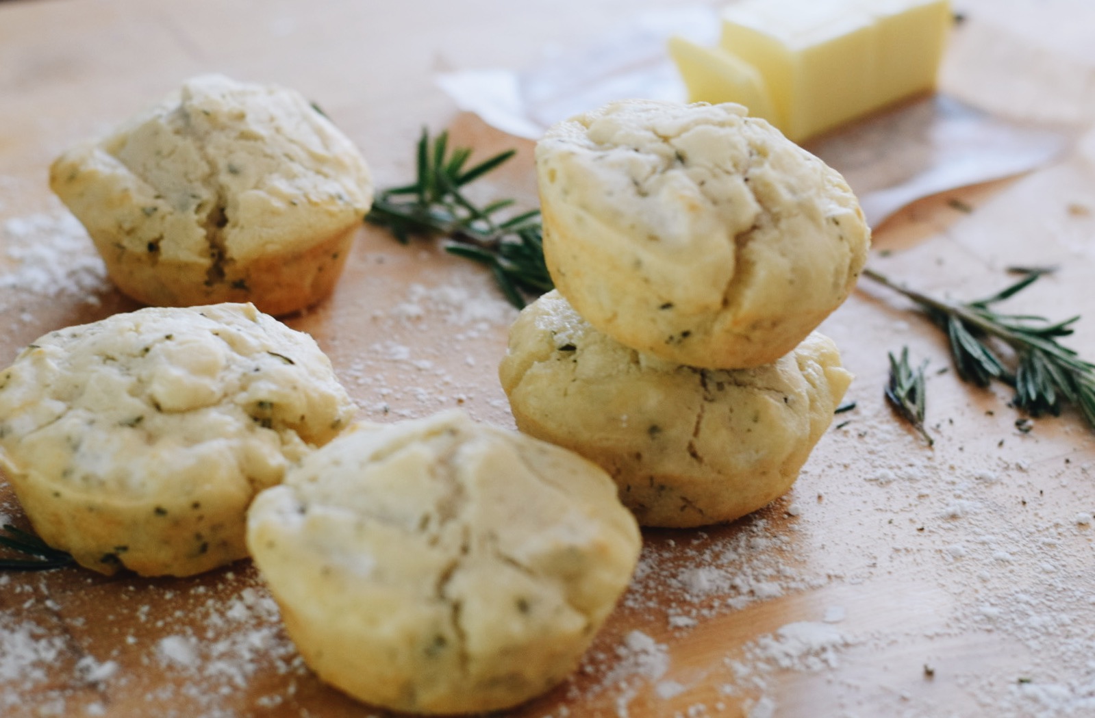 rosemary beer bread muffins on a wooden surface 