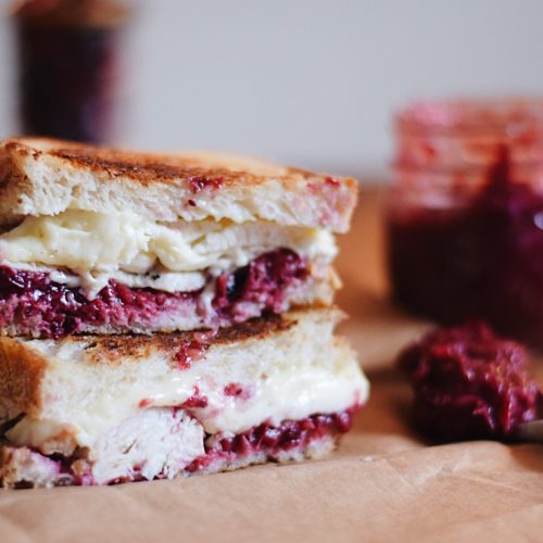 cranberry and brie sandwich on brown paper