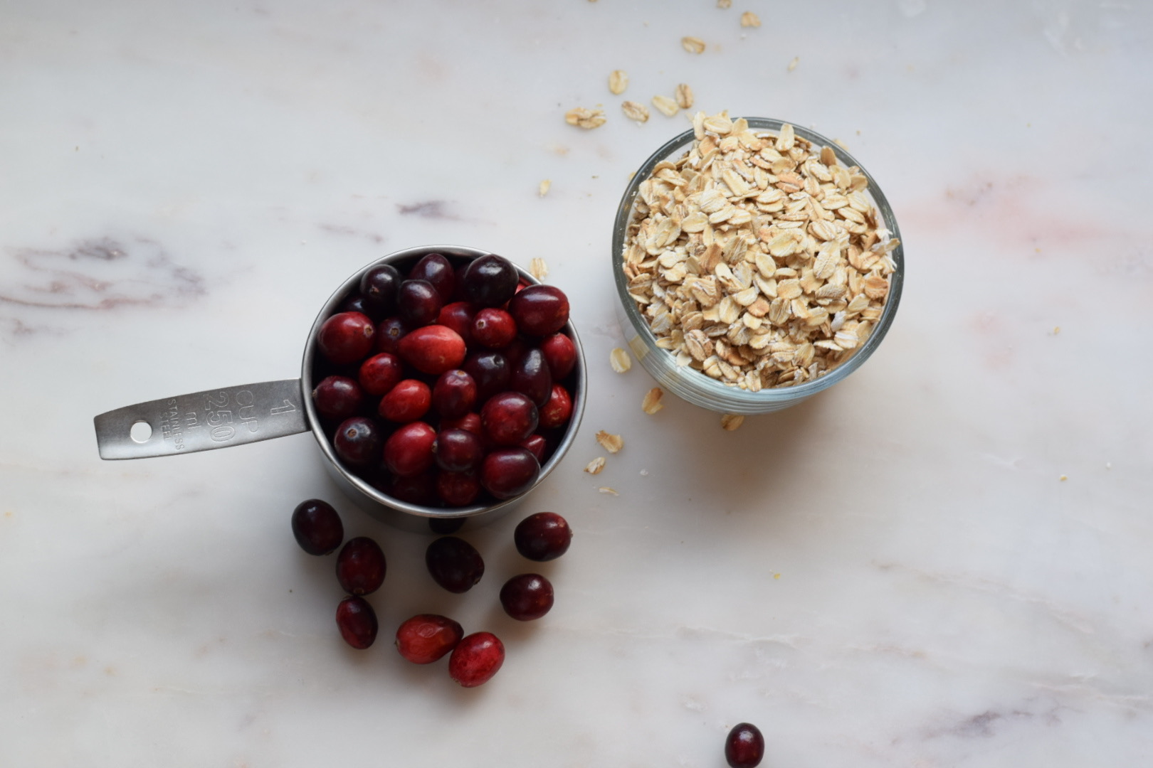 cranberries and oats in a measuring cup