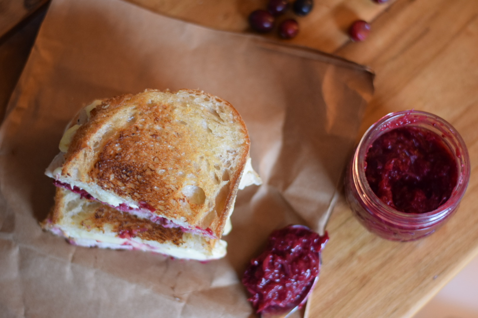 cranberry and brie sandwich on brown paper