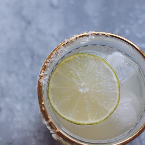 margarita with a lime slice on gray surface