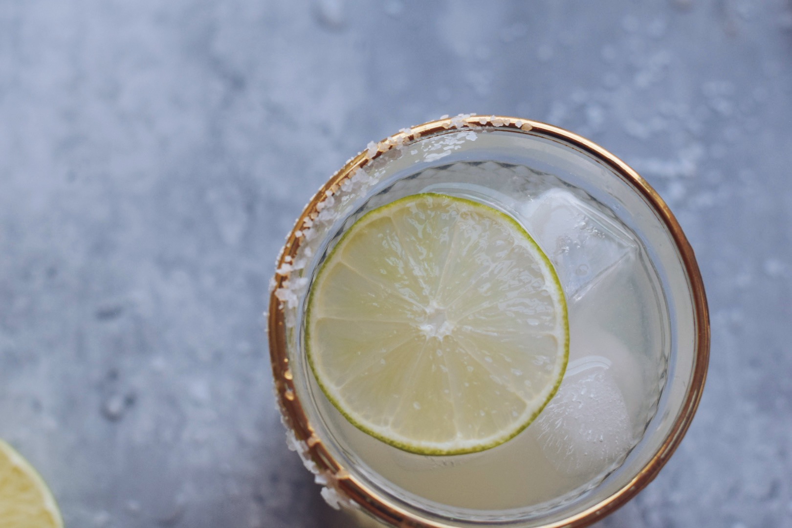 margarita with a lime slice on gray surface